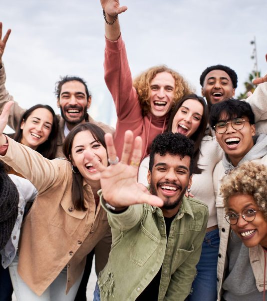 Big group of cheerful young friends taking selfie portrait. Happy people looking at the camera smiling. Concept of community, youth lifestyle and friendship. High quality photo